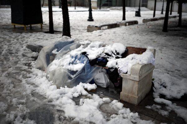 The belongings of a homeless person are covered with snow on Syntagma square, following heavy snowfall in Athens, Greece, on Jan. 25, 2022. (Alkis Konstantinidis/Reuters)