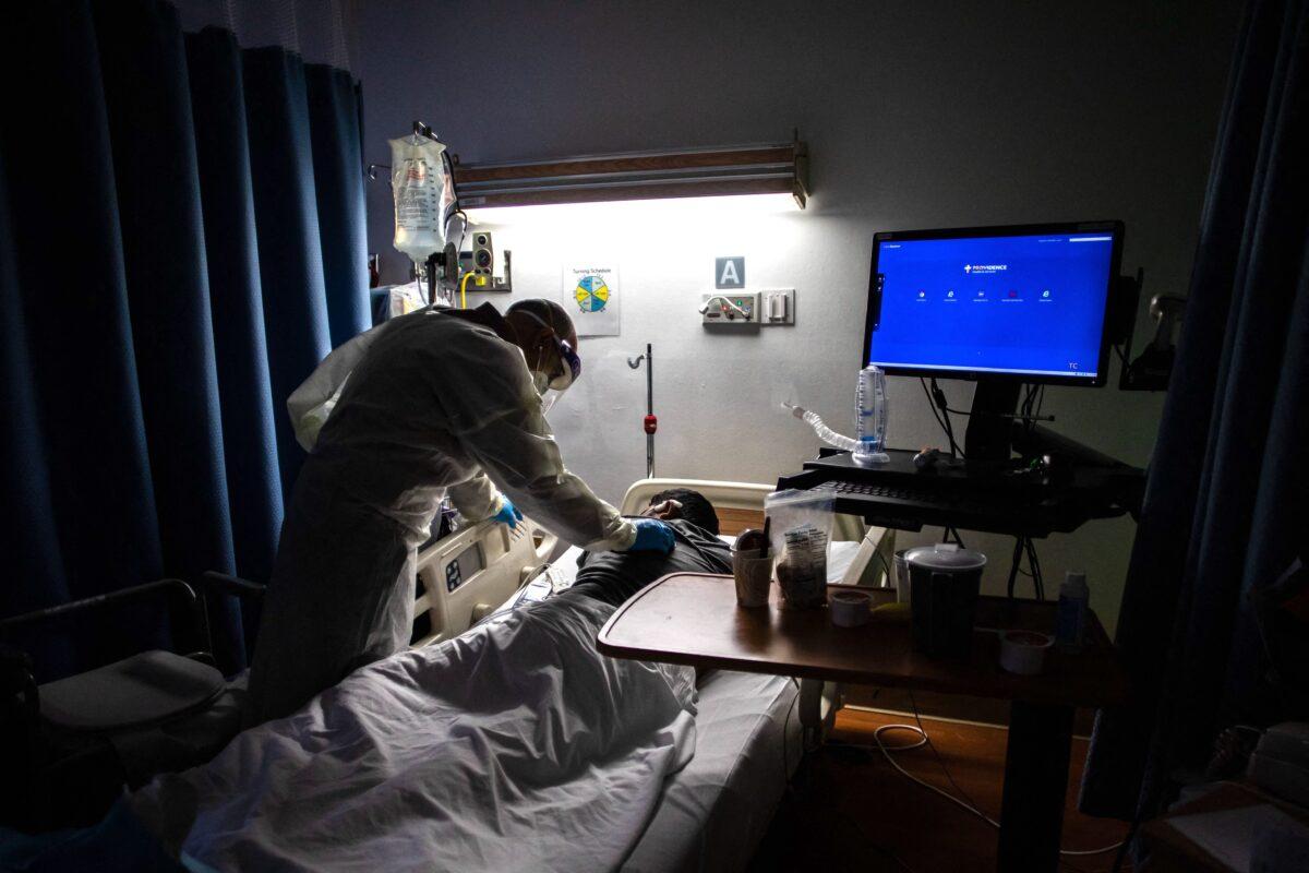 A doctor checks on a 34-years-old COVID-19 patient at a medical center in Tarzana, Calif., on Sept. 2, 2021. (Apu Gomes/AFP via Getty Images)