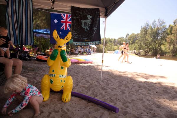 An inflatable boxing kangaroo is seen under a family's shade at the Nepean River Reserve in Menangle Park in Sydney, Australia, on Jan. 26, 2021. (Mark Kolbe/Getty Images)