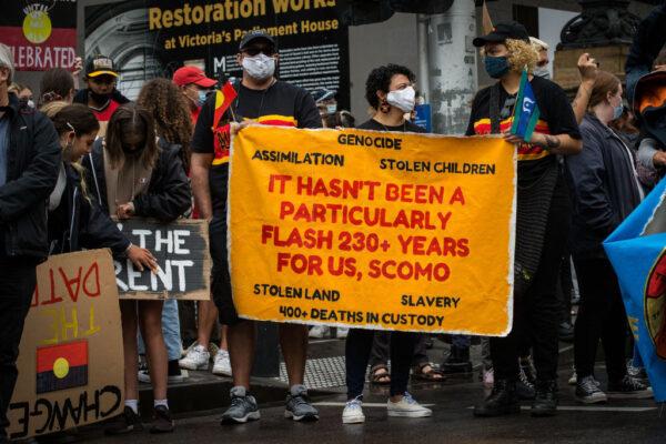 Protesters display signs at the Invasion Day rally in the city in Melbourne, Australia, on Jan. 26, 2021. (Darrian Traynor/Getty Images)