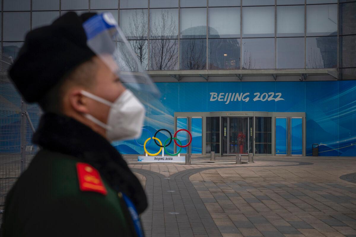 A security guard stands behind a barricade in an area not accessible to the general public, that will host Beijing 2022 Winter Olympics at Olympic Park in Beijing, China, on Jan. 23, 2022. (Andrea Verdelli/Getty Images)