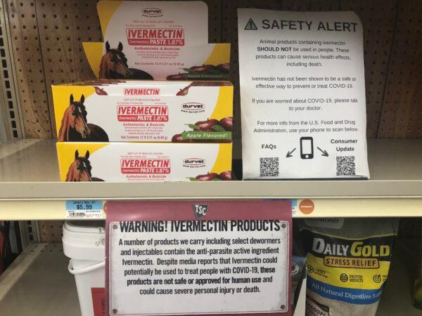Ivermectin pastes, formulated for deworming horses, are arranged on shelves behind warnings at Tractor Supply Company in Gainesville, Fla., on Jan. 25, 2022. (Nanette Holt/The Epoch Times)