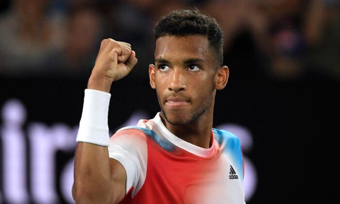 Felix Auger-Aliassime of Canada reacts after winning the second set against Daniil Medvedev of Russia, during their quarterfinal match at the Australian Open tennis championships in Melbourne, on Jan. 26, 2022. (Andy Brownbill/AP Photo)