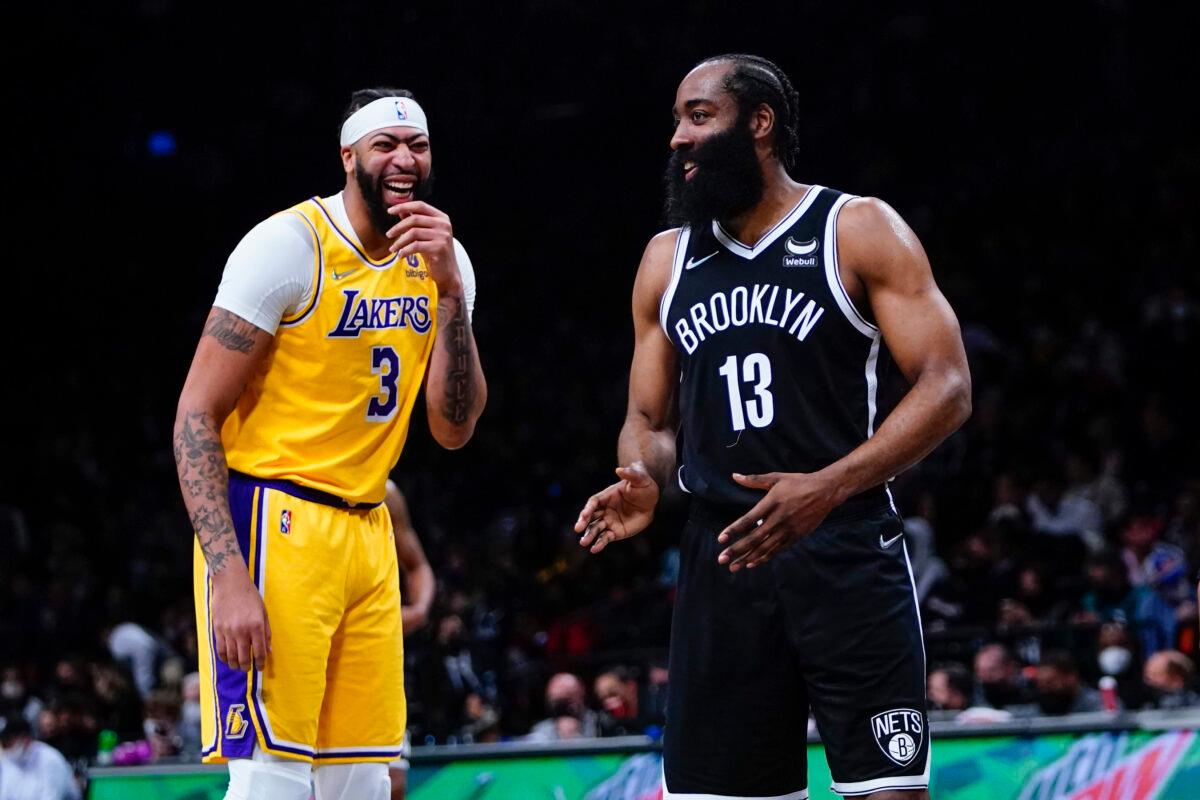 Los Angeles Lakers' Anthony Davis (3) laughs with Brooklyn Nets' James Harden (13) during the first half of an NBA basketball game, in New York City, on Jan. 25, 2022. (Frank Franklin II/AP Photo)