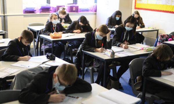 Year 8 students wear face masks or coverings as they take part in an English class at Park Lane Academy in Halifax, northwest England, on Jan. 4, 2022. (Oli Scarff/AFP via Getty Images)