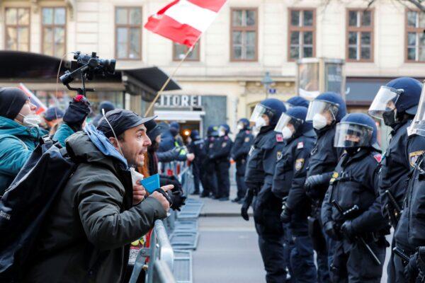 People scream at the police officers as they stop the demonstration march against the country's coronavirus restrictions around the ‘Vienna Ring’ in Vienna, on Jan. 8, 2022. (Lisa Leutner/AP Photo)