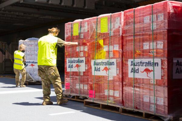 Humanitarian assistance and disaster relief stores are prepared for offloading as HMAS Adelaide sails into Tonga during OP TONGA ASSIST 22, on Jan. 26, 2022. (CPL Robert Whitmore/ADF)