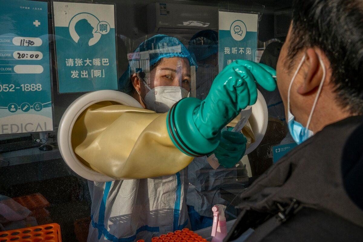A medical worker performs a PCR test in Beijing, China, on Jan. 10, 2022. (Andrea Verdelli/Getty Images)