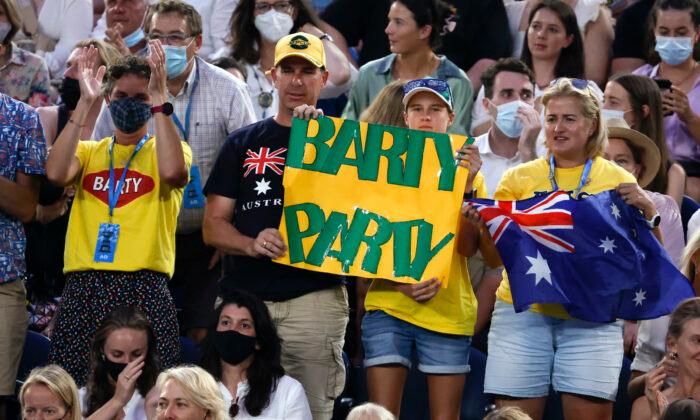 Supporters of Australia's Ash Barty hold up signs of support during her semifinal against Madison Keys of the United States at the Australian Open tennis championships in Melbourne, Australia, on Jan. 27, 2022. (Hamish Blair/AP Photo)