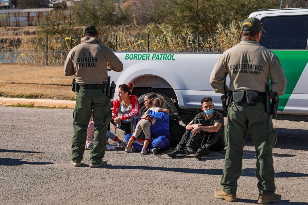 Border Patrol agents apprehend a group of Cubans and Venezuelans that had just waded across the Rio Grande from Mexico into Eagle Pass, Texas, on Jan. 25, 2022. (Charlotte Cuthbertson/The Epoch Times)