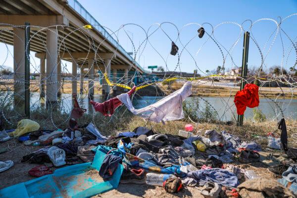Some of the piles of clothing and trash discarded by illegal immigrants after they cross the Rio Grande from Mexico under the international bridge into Eagle Pass, Texas, on Jan. 25, 2022. (Charlotte Cuthbertson/The Epoch Times)