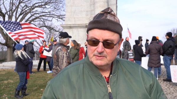 Edward, a former health care worker, attends the rally held in front of the Arch of the Valley Forge National Historical Park, Pa., on Jan. 23, 2022. (Screenshot via NTD)