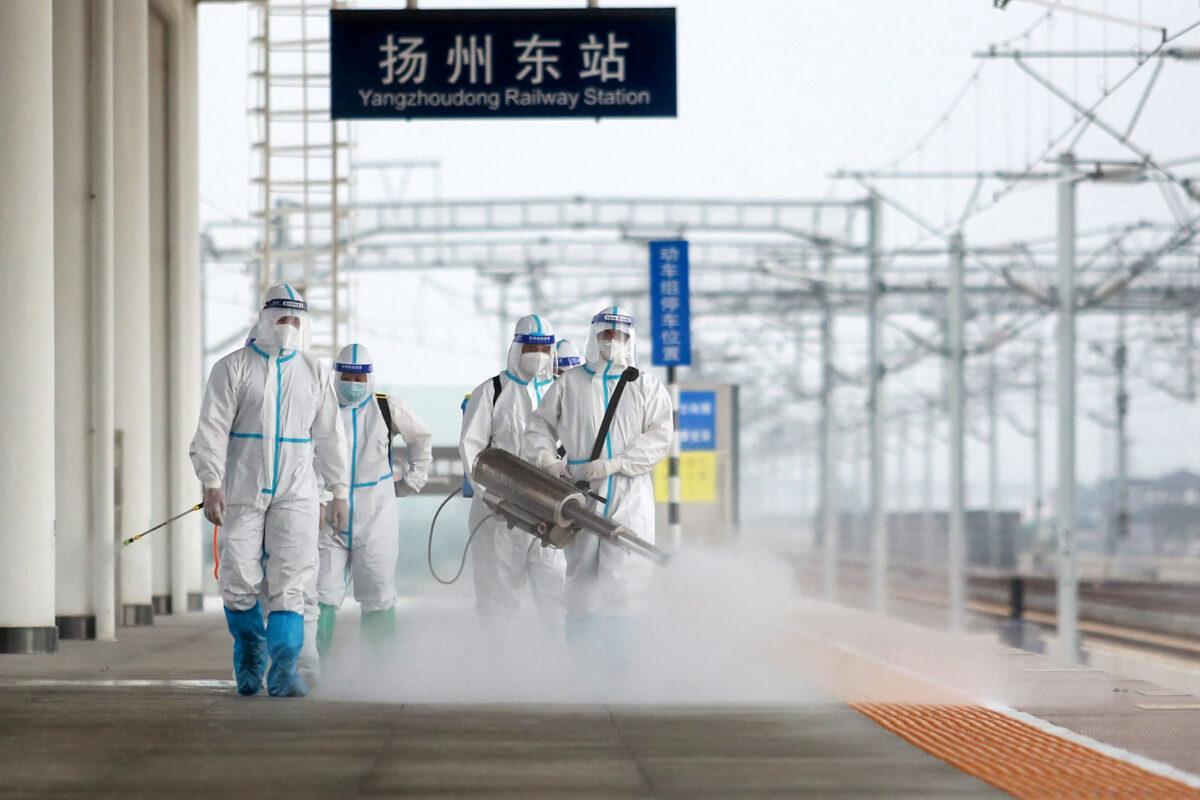 Firefighters spray disinfectant at the Yangzhou East train station in Yangzhou in China's eastern Jiangsu province on Sept. 16, 2021. (STR/AFP via Getty Images)