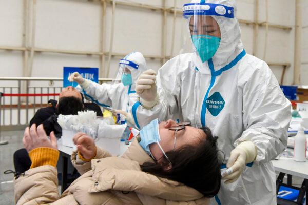 Residents are swabbed for COVID-19 testing in Ningbo in eastern China's Zhejiang Province on Jan. 16. (STR/AFP via Getty Images)