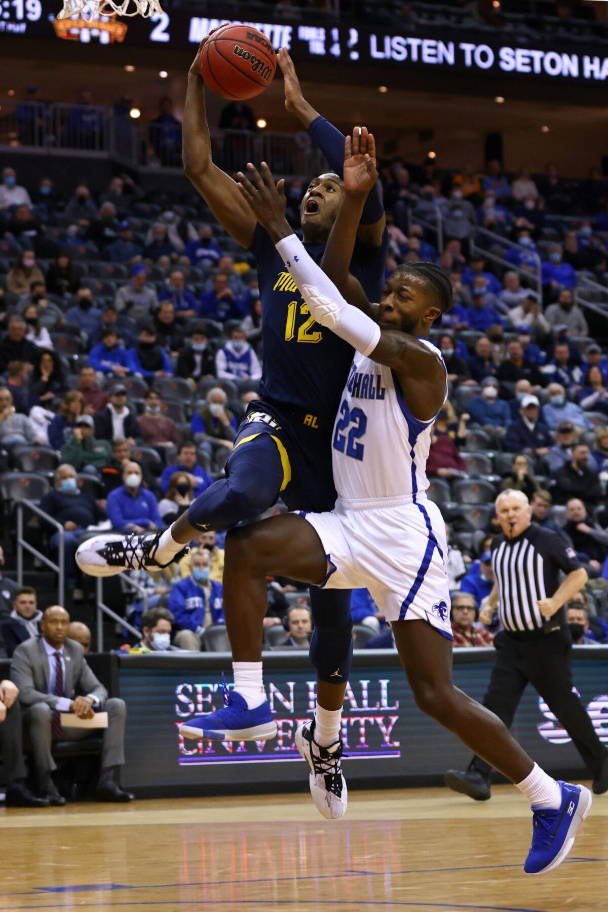Olivier-Maxence Prosper #12 of the Marquette Golden Eagles attempts a shot as Myles Cale #22 of the Seton Hall Pirates defends during the first half of a game at Prudential Center in Newark, N.J., on Jan. 26, 2022. (Rich Schultz/Getty Images)