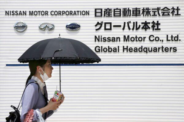 A woman walks past the global headquarters of Nissan Motor Co., Ltd. in Yokohama near Tokyo, on May 27, 2020. (Koji Sasahara/AP Photo)
