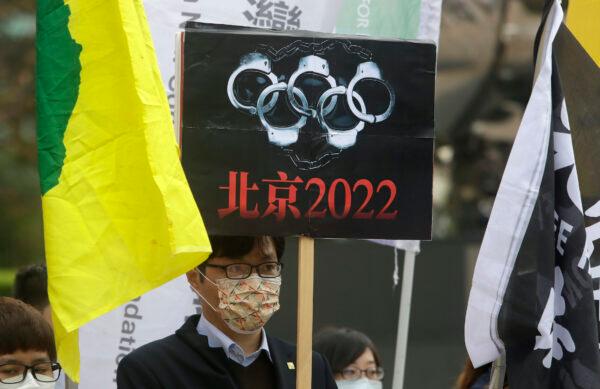 Human rights groups gather on the U.N.'s International Human Rights Day to call for a boycott of the Beijing Winter Olympics 2022, in front of the Bank of China building in Taipei, Taiwan, on Dec. 10, 2021. (Chiang Ying-ying/AP Photo)