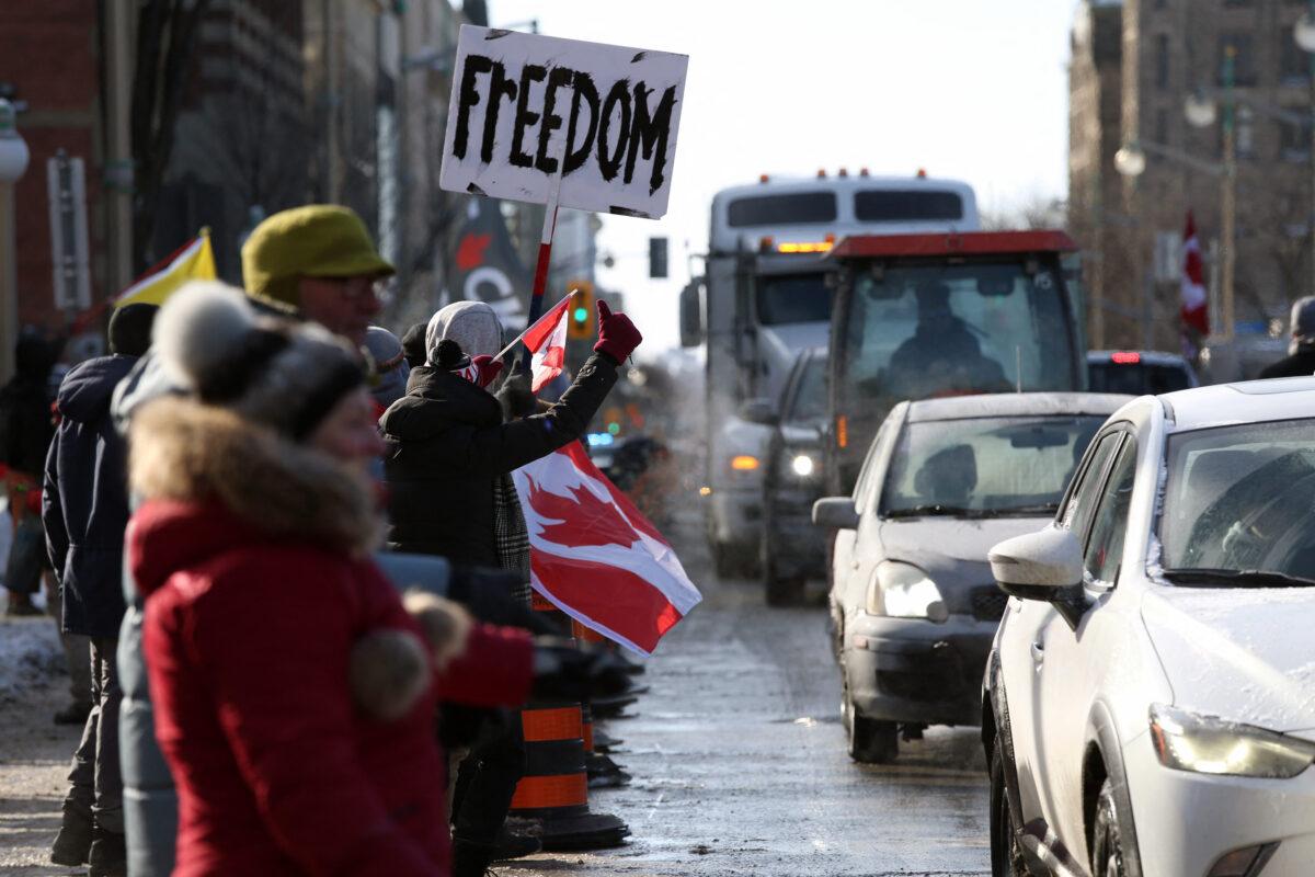 Supporters of the Freedom Convoy protest against COVID-19 vaccine mandates and restrictions in front of Parliament of Canada, in Ottawa, Canada, on Jan. 28, 2022. A convoy of truckers started from Vancouver on Jan. 23, 2022, on its way to protest against the mandate in the capital city of Ottawa. (Dave Chan/AFP via Getty Images)