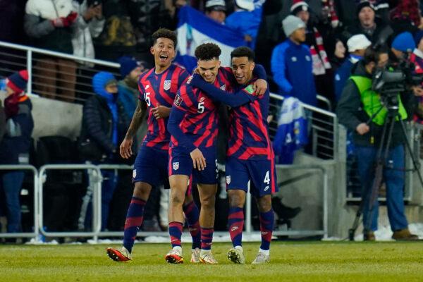 United States’ Antonee Robinson (5) celebrates his goal with Chris Richards (15) and Tyler Adams (4) during the second half of a FIFA World Cup qualifying soccer match against El Salvador in Columbus, Ohio, on Jan. 27, 2022. (Julio Cortez/AP Photo)
