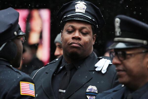 Many officers were emotional during the funeral of Jason Rivera at St Patrick's Cathedral in New York on Jan. 28, 2022. (Richard Moore/The Epoch Times)