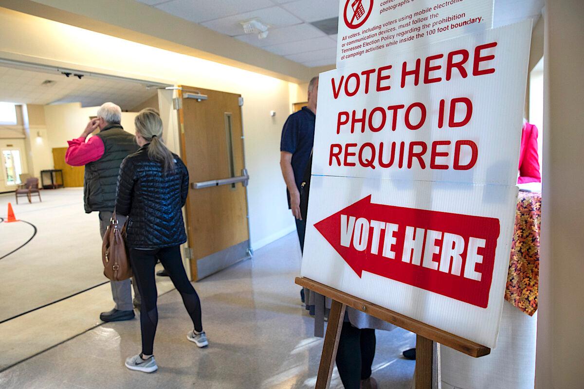 A sign reminds voters they need photo ID to vote at polling station in Nashville, Tenn., on Nov. 6, 2018. (Drew Angerer/Getty Images)