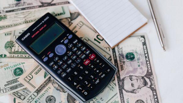 A stock photo of a calculator on dollar bank notes. (Karolina Grabowska/Pexels)