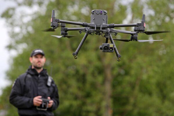 Acting Police Sergeant Chris Linzey pilots a DJI Matrice M300 drone (UAV) during a demonstration for media ahead of the upcoming in-person G-7 Summit in Cornwall, at the Police headquarters in Exeter, southwest England, on May 25, 2021. (GEOFF CADDICK/AFP via Getty Images)