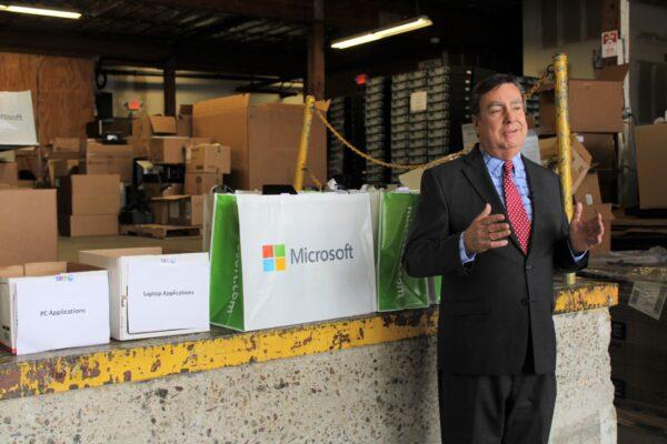 San Diego County Supervisor Joel Anderson stands with refurbished County computers ready for distribution. (Courtesy of San Diego County Supervisor Joel Anderson)