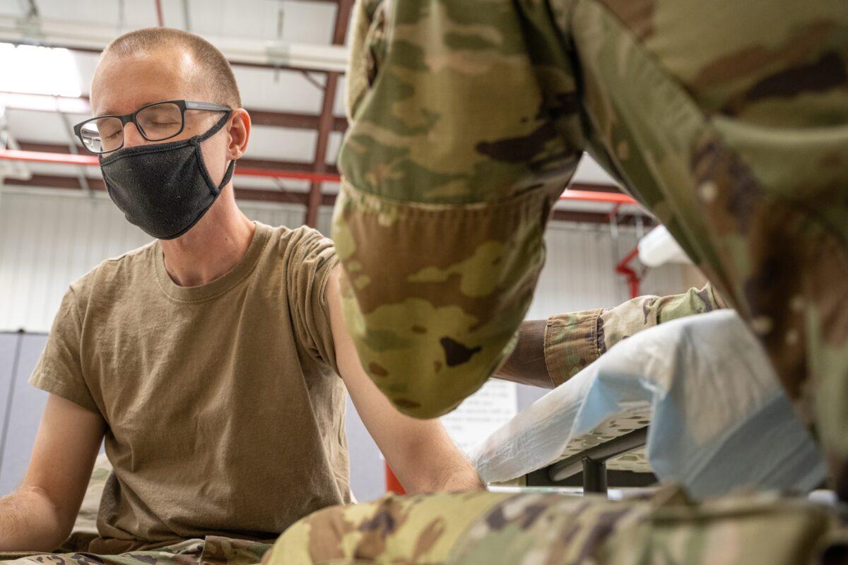 A military member gets a COVID-19 vaccine in Fort Knox, Ky., in a file image. (Jon Cherry/Getty Images)