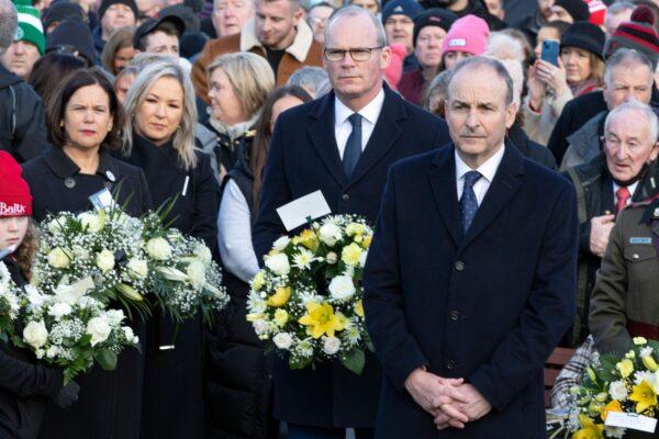 Irish republican Sinn Fein party leader Mary Lou McDonald (L), Deputy First Minister Sinn Fein's northern leader Michelle O'Neill (2nd L), Ireland foreign minister Simon Coveney (C), and Ireland's Taoiseach (Prime Minister) Michael Martin (2nd R) attend a wreath-laying ceremony at a monument to victims of Bloody Sunday, in Londonderry (Derry), Northern Ireland, on Jan. 30, 2022. (Paul Faith/AFP via Getty Images)