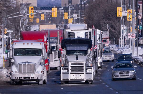Trucks from the convoy protest against COVID-19 mandates and restrictions are parked on a road in Ottawa on Jan. 30, 2022. (The Canadian Press/Adrian Wyld)