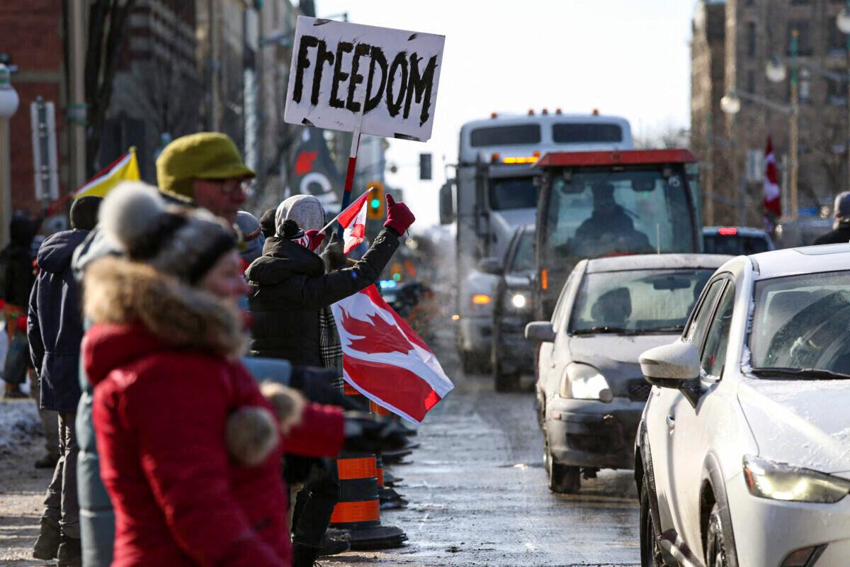 Supporters of the Freedom Convoy protest against COVID-19 vaccine mandates and restrictions in front of Parliament of Canada, in Ottawa, Canada, on Jan. 28, 2022. A convoy of truckers started off from Vancouver, Canada, on Jan. 23, 2022, on its way to protest against the mandate in the capital city of Ottawa. (Dave Chan/AFP via Getty Images)