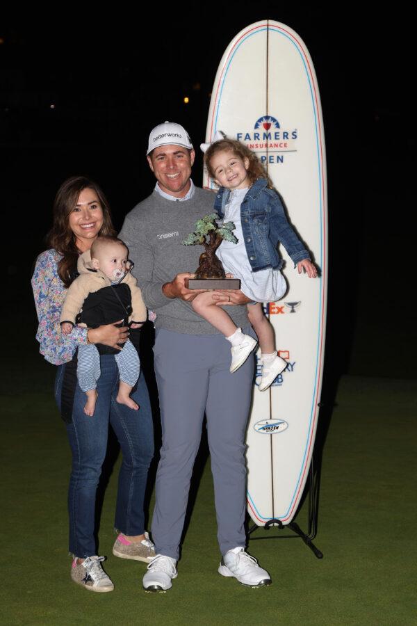 Luke List and his family celebrate with the trophy after winning The Farmers Insurance Open at Torrey Pines Golf Course in La Jolla, Calif., on Jan. 28, 2022. (Sam Greenwood/Getty Images)