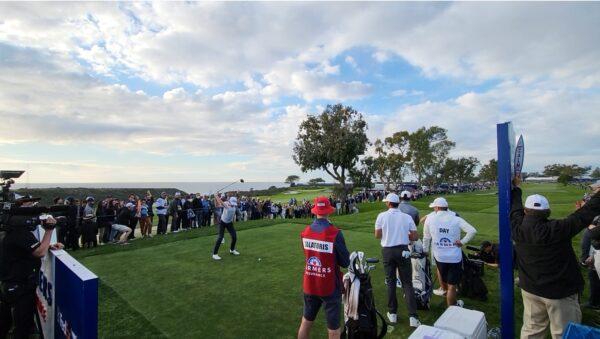 Will Zalatoris hitting his tee shot on hole #15 as Jason Day washes, at The Farmers Insurance Open, at the South Course at Torrey Pines Golf Course in La Jolla, Calif., on Jan. 28, 2022. (Nhat Hoang/Epoch Times)