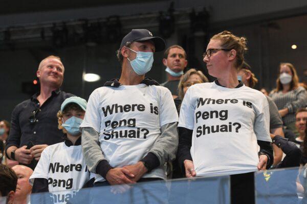 Spectators wearing "Where is Peng Shuai?" T-shirts, referring to the former doubles world number one from China, are pictured in the stands during the women's singles final match between Australia's Ashleigh Barty and Danielle Collins of the U.S. on day thirteen of the Australian Open tennis tournament in Melbourne, on Jan. 29, 2022. (William West/AFP via Getty Images)
