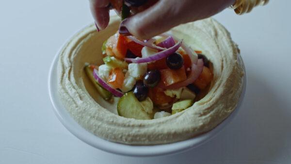 Hummus Topped With Greek Salad featured in "Breaking Bread." (Cohen Media Group)