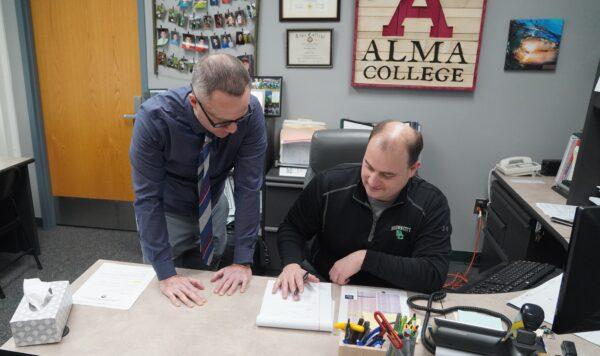 Superintendent Neil Kohler (left) confers with Brown City Elementary Principal Sean Hagey in Brown City, Mich., on Jan. 28, 2022. (Steven Kovac/The Epoch Times)