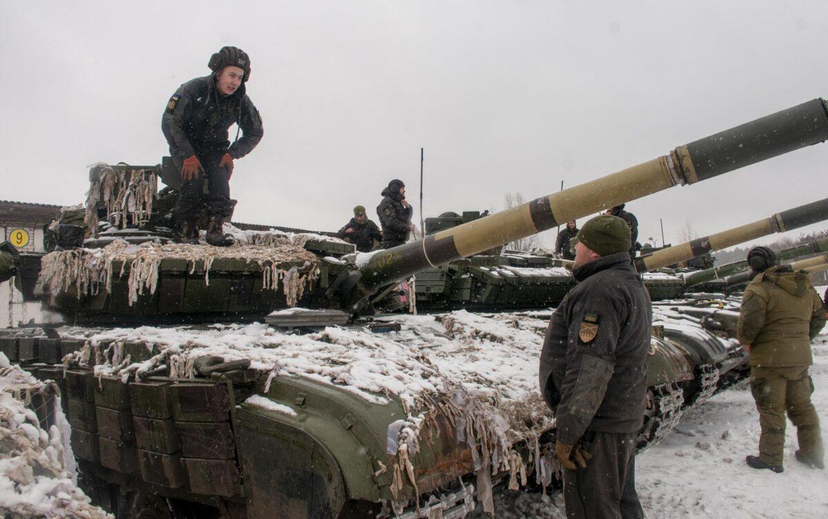 Ukrainian soldiers examine their tanks at a military unit close to Kharkiv, Ukraine, on Jan. 31, 2022. (Andrew Marienko/AP Photo)