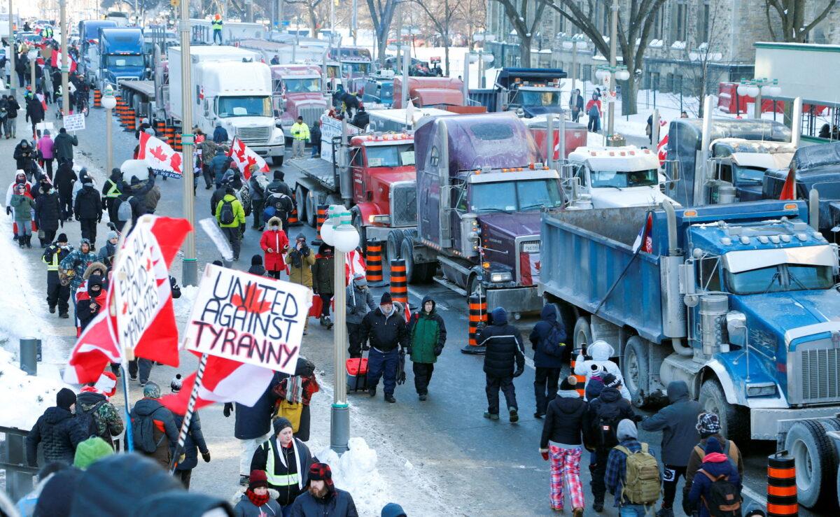 Trucks sit parked on Wellington Street near the Parliament Buildings as truckers and their supporters take part in a convoy to protest COVID-19 vaccine mandates for cross-border truck drivers in Ottawa, Canada, on Jan. 29, 2022. GoFundMe took $10 million away from the Canadian protests against vaccine mandates. (Patrick Doyle/Reuters)