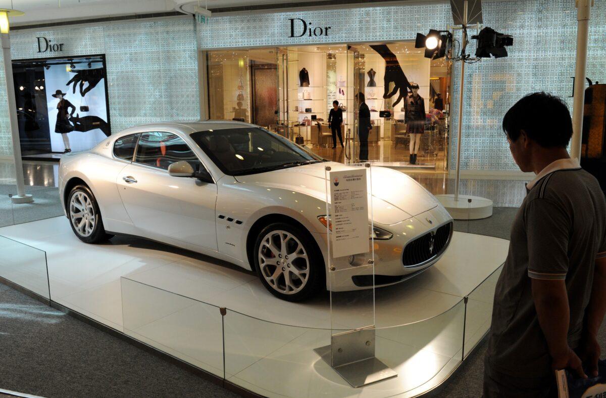 A man looks at a Maserati sports car on display at a luxury mall in Shanghai on Sept. 16, 2011. (Mark Ralston/AFP via Getty Images)
