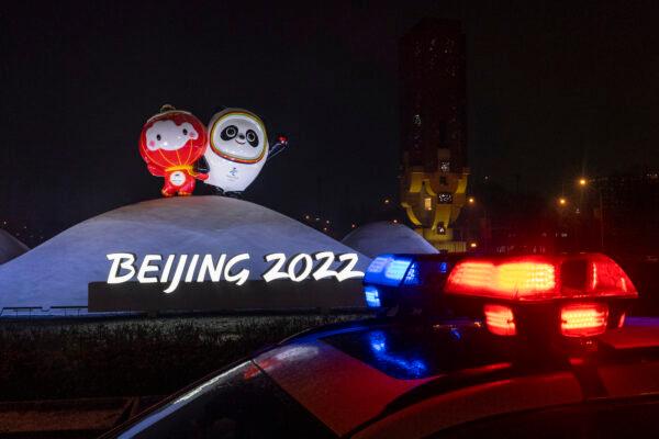 A police car is parked in front of a display for the Beijing 2022 Winter Olympics during a rehearsal for the opening ceremony on Jan. 30, 2022, in Beijing, China. (Photo by Andrea Verdelli/Getty Images)