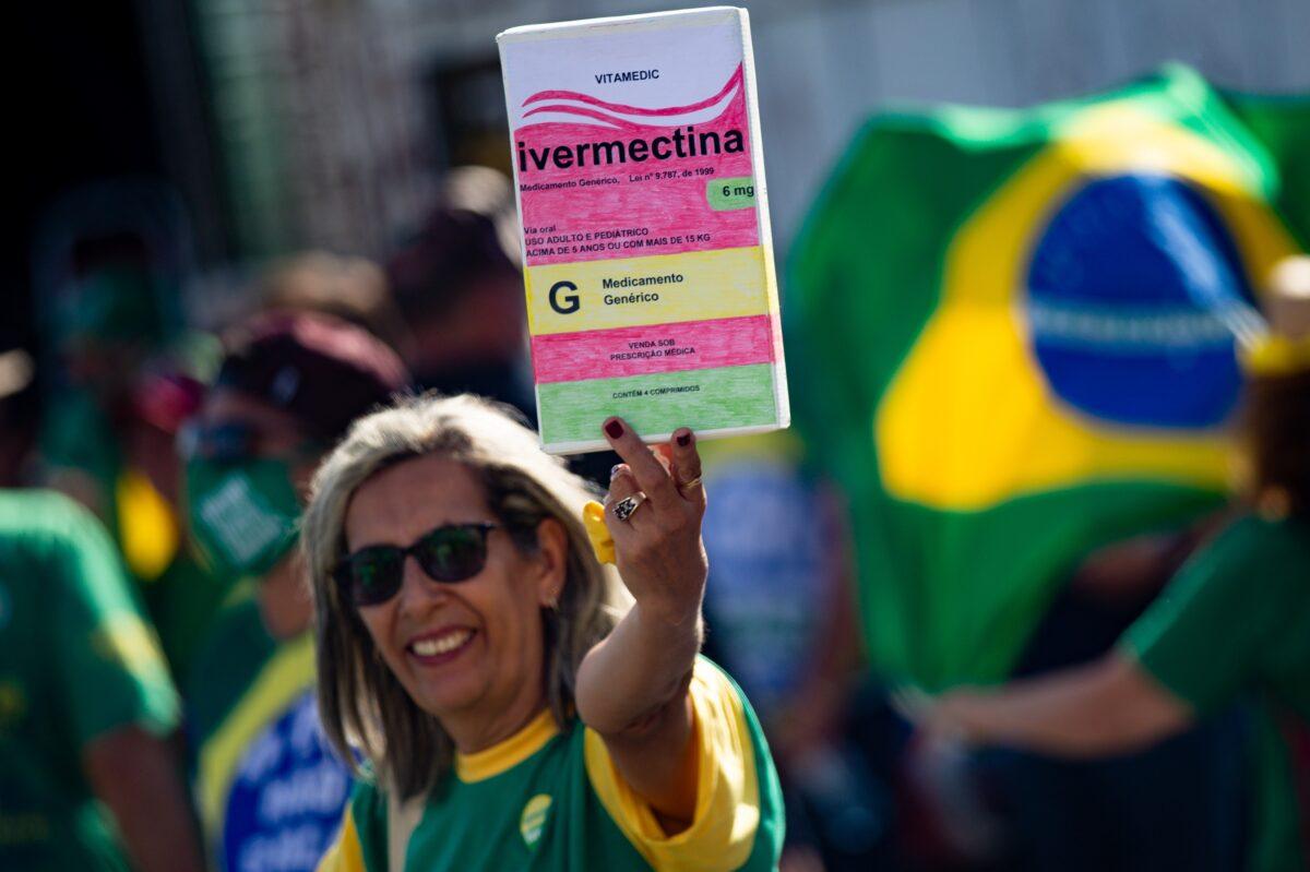 A woman holds a box of ivermectin in Brasilia, Brazil, in a file image. (Andressa Anholete/Getty Images)