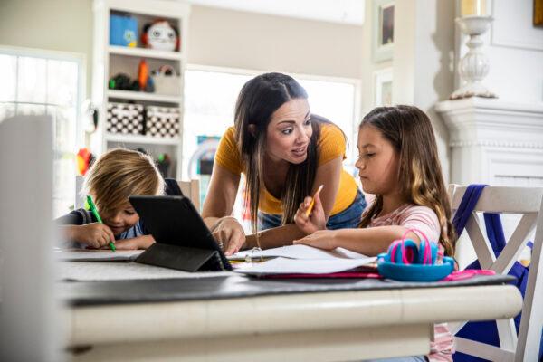 Undated image of a mother working from home and homeschooling children. (MoMo Productions/Getty)