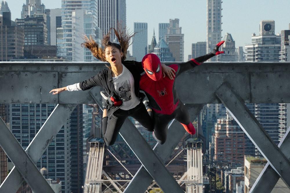 Spider-Man (Tom Holland) base-jumps without a parachute to get girlfriend MJ (Zendaya) out of danger, in "Spider-Man: No Way Home." (Marvel Studios/Columbia Pictures)