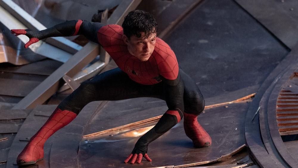 An unmasked Spider-Man (Tom Holland) doing the now-classic superhero landing, in "Spider-Man: No Way Home." (Marvel Studios/Columbia Pictures)