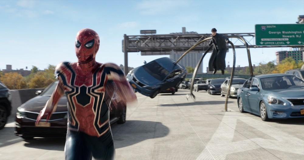 Spider-Man (Tom Holland) running from a car-slinging Doc Ock (Alfred Molina), in "Spider-Man: No Way Home." (Marvel Studios/Columbia Pictures)
