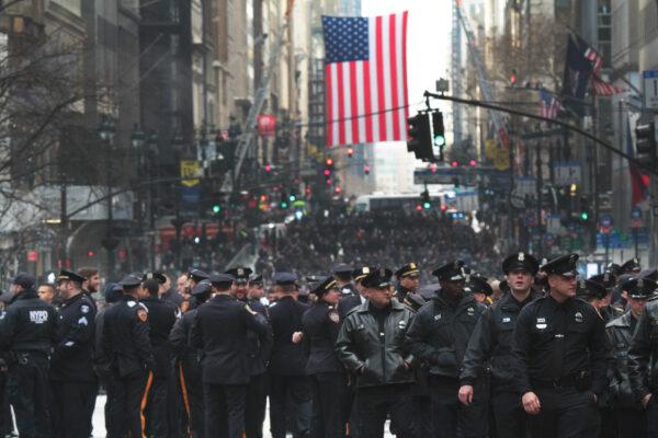Thousands of New York police officers took over Fifth Ave. near St. Patrick's Cathedral for the funeral of officer Wilbert Mora, who was fatally shot in the line of duty, in New York on Feb. 2, 2022. (Richard Moore/The Epoch Times)