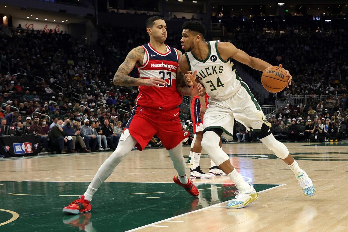 Giannis Antetokounmpo #34 of the Milwaukee Bucks is defended by Kyle Kuzma #33 of the Washington Wizards during the first half of a game at Fiserv Forum, in Milwaukee, on Feb. 1, 2022. (Stacy Revere/Getty Images)