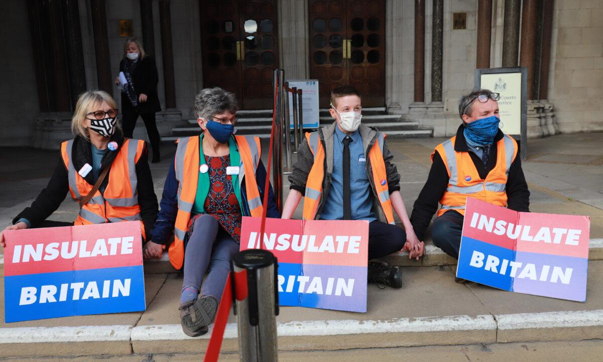 (L–R) Insulate Britain activists Theresa Norton, Diana Warner, El Litten, and Steve Pritchard glued outside the Royal Courts of Justice in London on Feb. 1, 2022. (Denise Laura Baker/Insulate Britain)