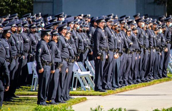 Los Angeles Police Department (LAPD) and Los Angeles Sheriff's Department officers pay respects at the memorial service of LAPD Officer Fernando Arroyos in Los Angeles on Feb. 2, 2022. (John Fredricks/The Epoch Times)